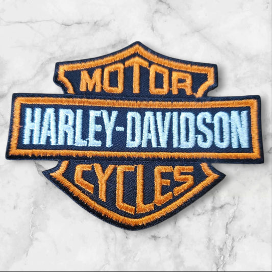 Orange & Black Embroidered Shield Patch â Bold Stripe Design